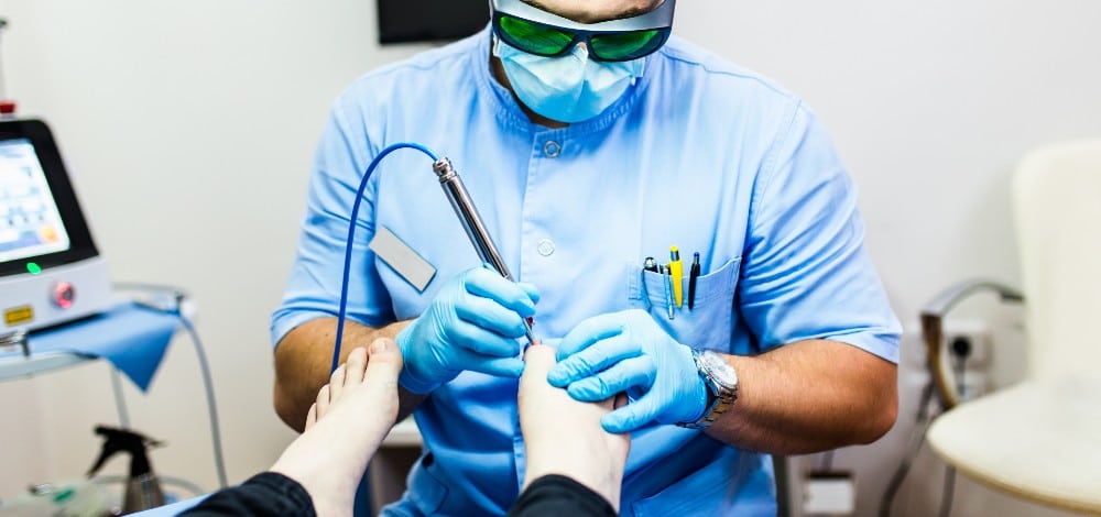 Patient receiving laser treatment on foot