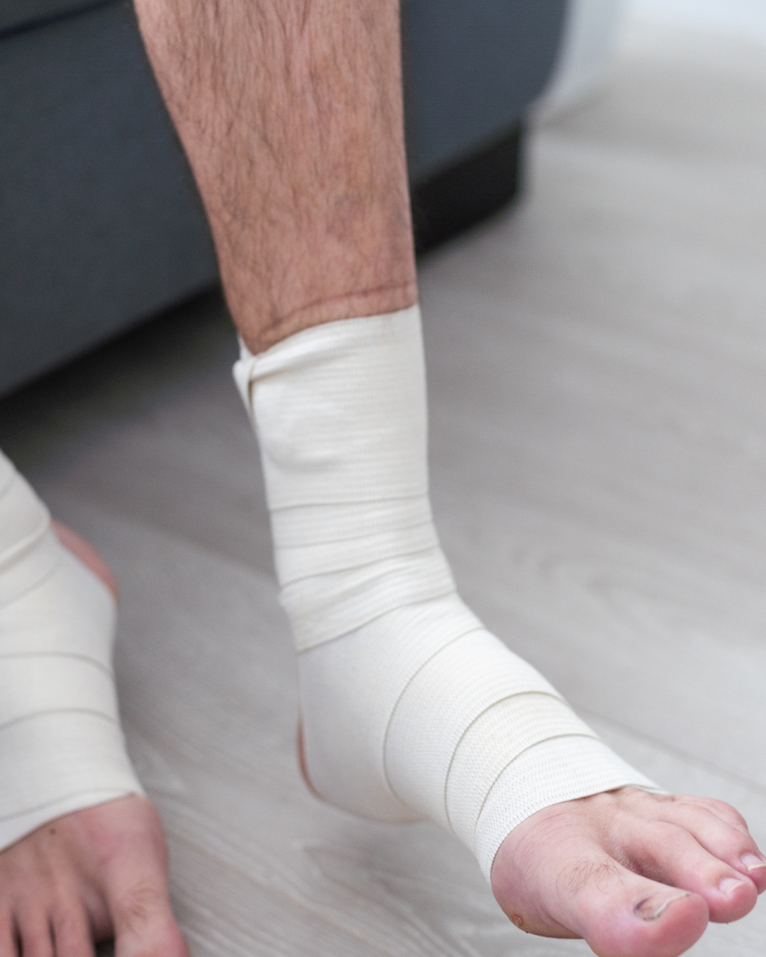 man using put on elastic bandage with legs having leg pain
